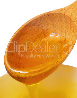 wooden spoon with honey isolated