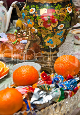 Russian samovar on a table with sweets