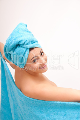 young beautiful woman with a towel doing wellness