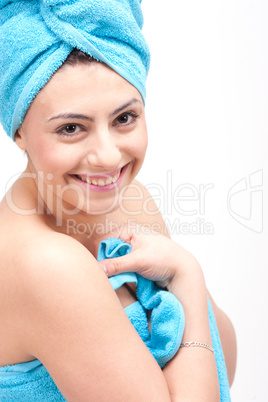 young beautiful woman with a towel doing wellness