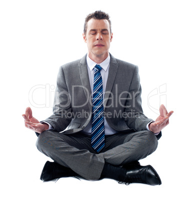 Businessman meditating in lotus position