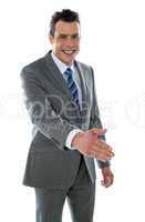 Confident modern businessman offering handshake
