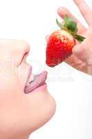 close-up woman?s lips and a strawberry