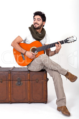 young man is playing a guitar and singing