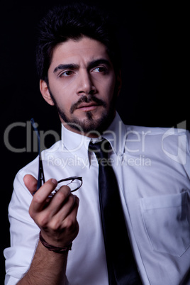 young successful business man with a suit isolated on black background