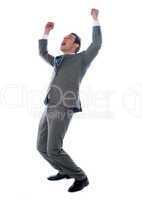 Successful businessman celebrating with arms up