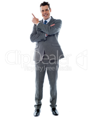 Businessman in suit pointing at copyspace