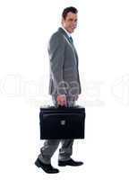 Going business man holding briefcase