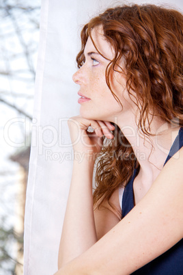 young beautiful woman with red hair and blue eys