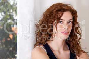young beautiful woman with red hair and blue eys