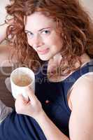 young beautiful woman with red hair and a cup of coffee
