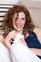 young beautiful woman with red hair and a cup of coffee