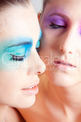 young beautiful woman with an extreme colorfull make up portrait
