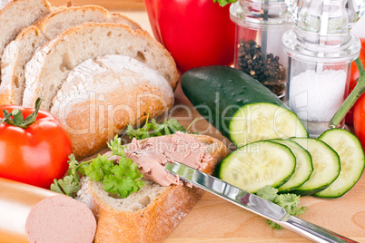 breakfast or lunch with mixed vegetables, sausage and a knife