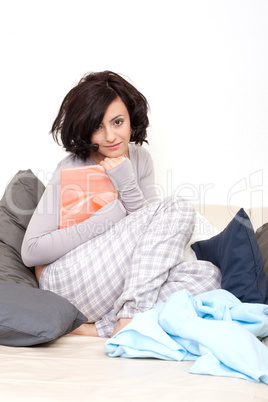 beautiful woman is sitting on the sofa an reading a book