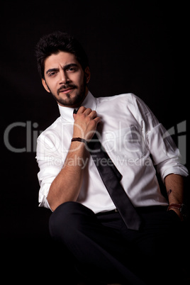 young successful business man with a suit isolated on black background