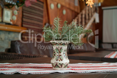 Spruce branch in a folk vase