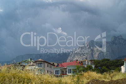 Cliffs and houses under stormy sky