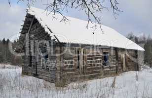 Old broken house in winter