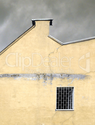 Old broken wall on a  storm sky background