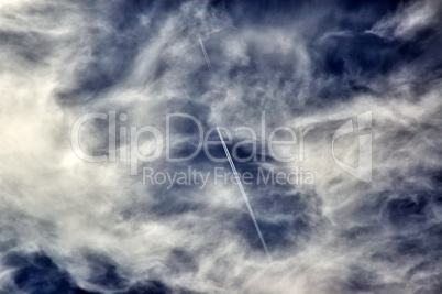 The cloudy sky and vapor trail of two planes