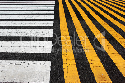 white and yellow stripes crosswalk