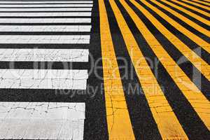 white and yellow stripes crosswalk