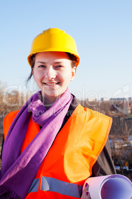 Young lady architect staying outdoors