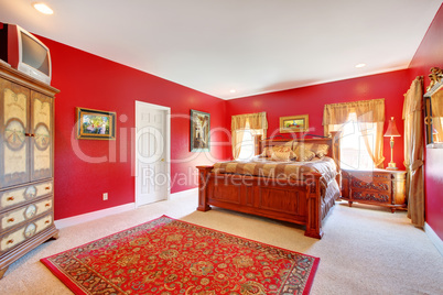 Red classic bedroom with large bed.