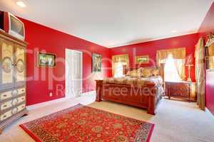 Red classic bedroom with large bed.