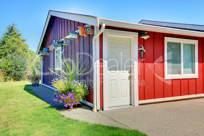 Shed in purple and red with bird houses.