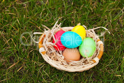 Basket with the colorful Easter eggs