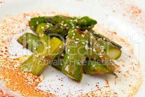 Fried Asparagus on white plate