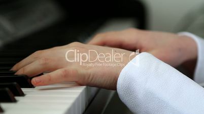 Girl playing piano close up