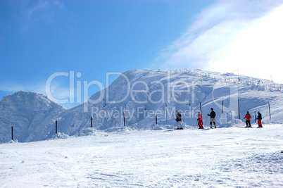 JASNA-MARCH 15: Skiers on a slope and view on Chopok peak in Jas