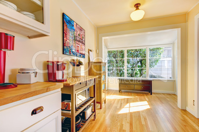 Kitchen corner with large window and bench.