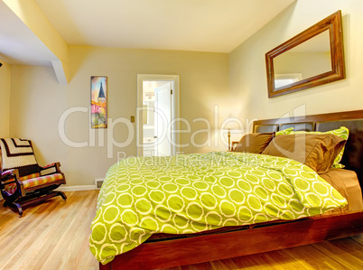 Modern bedroom with bright green bed spread.