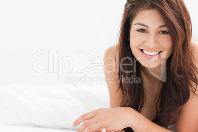 Woman smiling while slighlty crossing her hands and looking forw