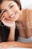 Close up Woman with a hand on her cheek, smiling and looking str