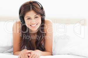 Woman tilting her head slightly while listening to music and smi