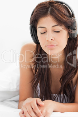 Close up, woman listening to her headphones with her eyes closed