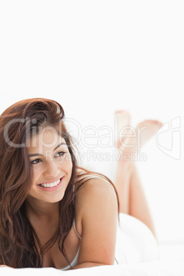 Close up, woman with legs crossed while smiling and looking to t