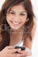 Close up, Smiling woman with her smartphone in hand