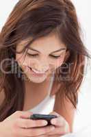 Close up, woman using her smartphone and smiling