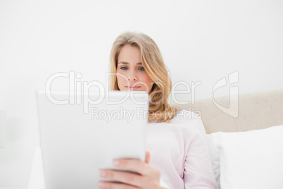 Low angle shot, woman looking at tablet pc