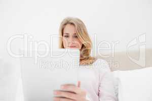 Low angle shot, woman looking at tablet pc