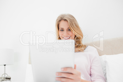 Low angle shot, woman using tablet pc and smiling