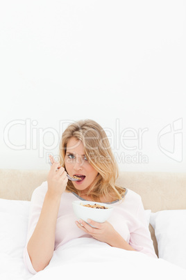 Vertical shot, woman looking forward, about to eat a spoon of ce