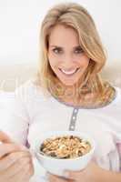 Close up, woman looking forward and smiling as she gets a spoon