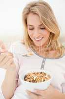 Close up, Woman looking at a spoon of cereal raised near to her